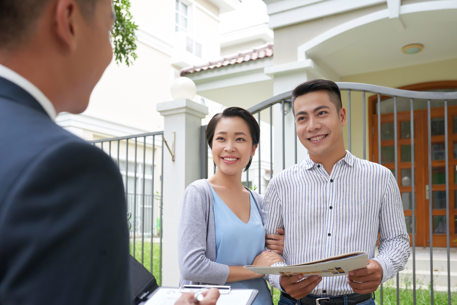 Villa owner meeting with property manager outside a villa